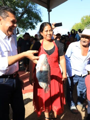 Dos productores tabasqueños posan con tilapias recién cosechadas en la ribera de Centla, mostrando los resultados del programa Pescando Vida impulsado por el Gobierno del Estado.