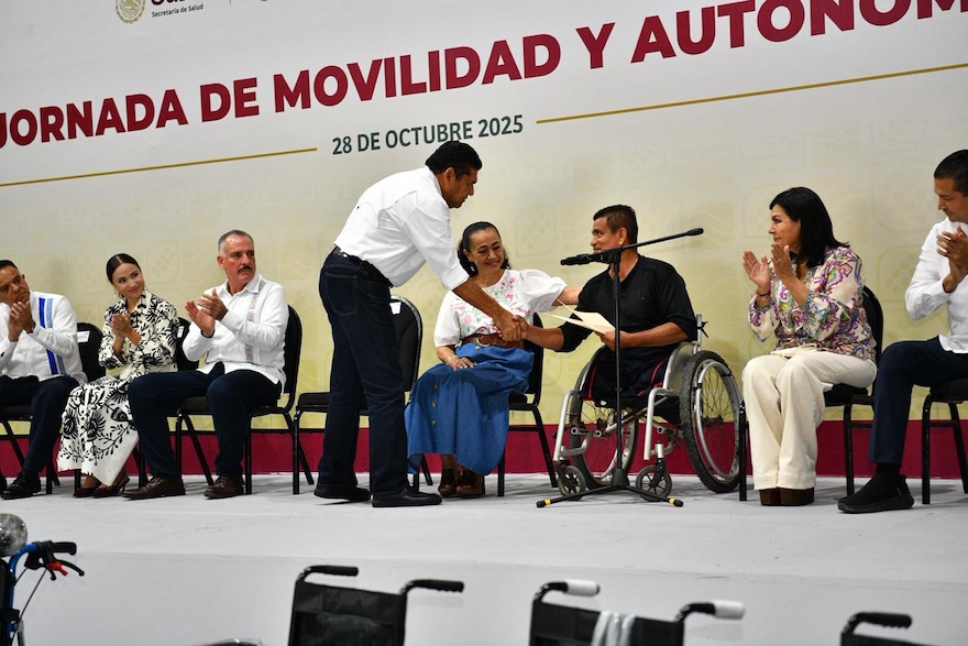 Javier May entrega reconocimiento a beneficiario en silla de ruedas durante el evento oficial.