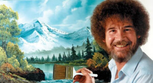 Bob Ross pintando un paisaje con "árboles felices" durante su programa, antes de la subasta de sus cuadros originales.