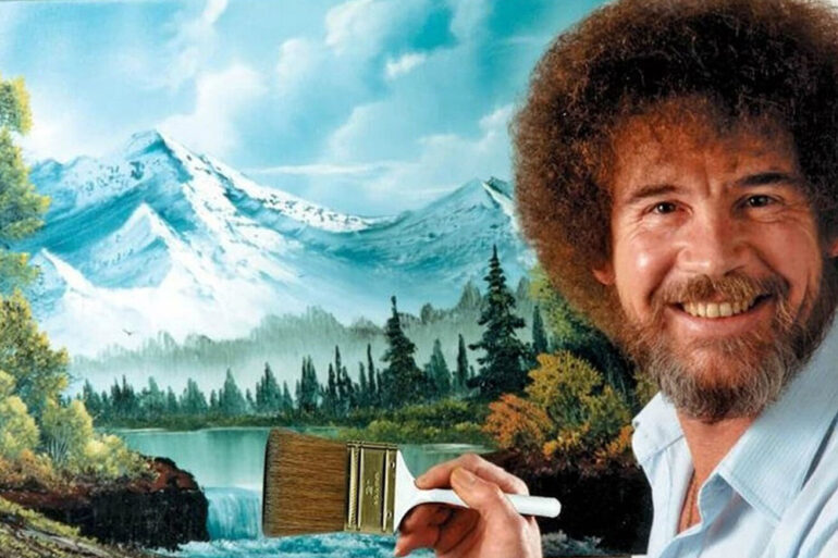 Bob Ross pintando un paisaje con "árboles felices" durante su programa, antes de la subasta de sus cuadros originales.