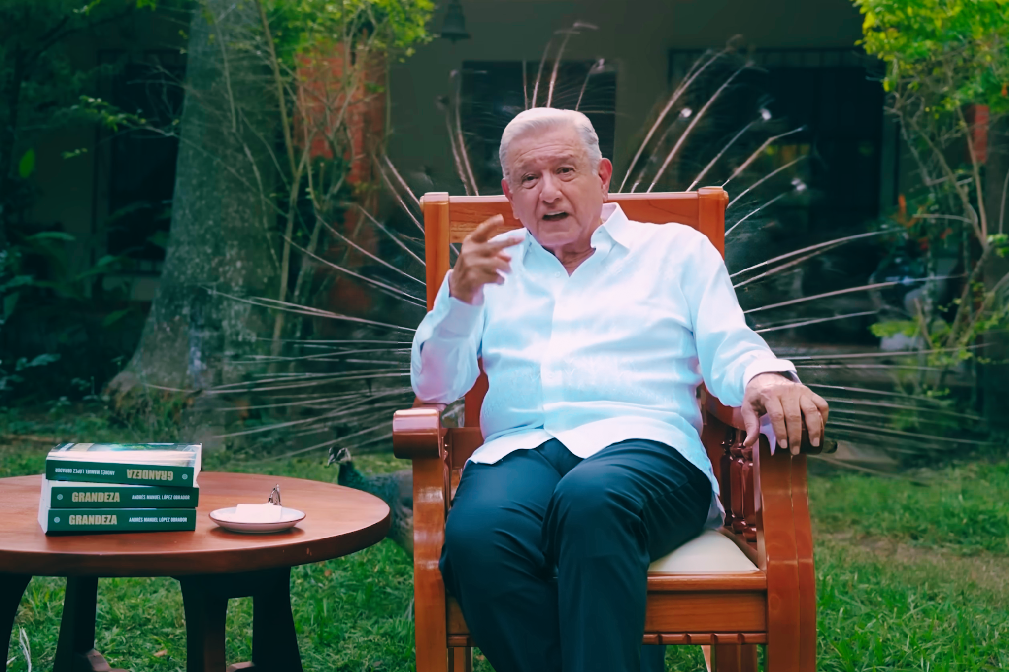 Andrés Manuel López Obrador durante el mensaje difundido desde su quinta en Palenque, sentado frente a una mesa de madera y una fotografía familiar.