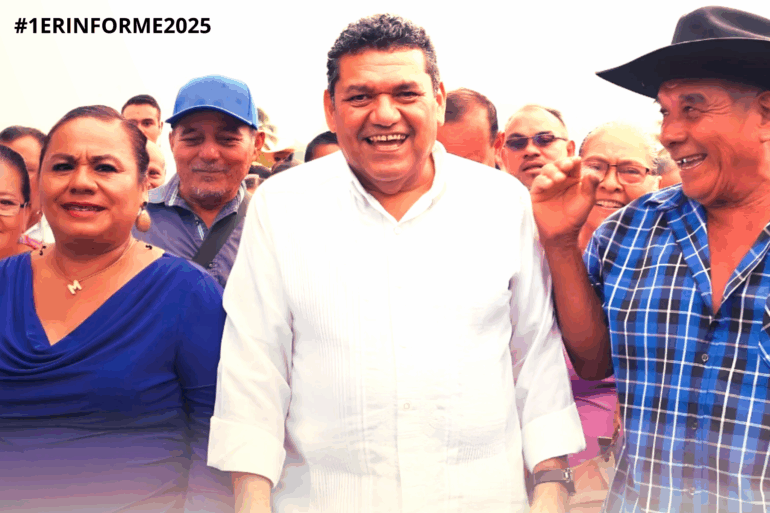 Un hombre sonriente con camisa blanca camina rodeado de vecinos que también sonríen.