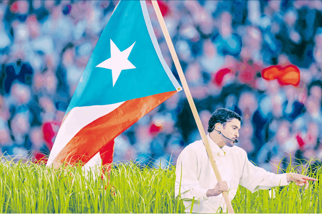 Bad Bunny porta bandera de Puerto Rico azul celeste frente a estadio lleno.