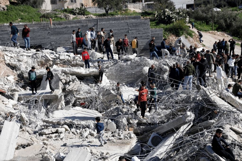 Civiles palestinos observan los escombros de edificaciones tras una operación militar en Cisjordania.