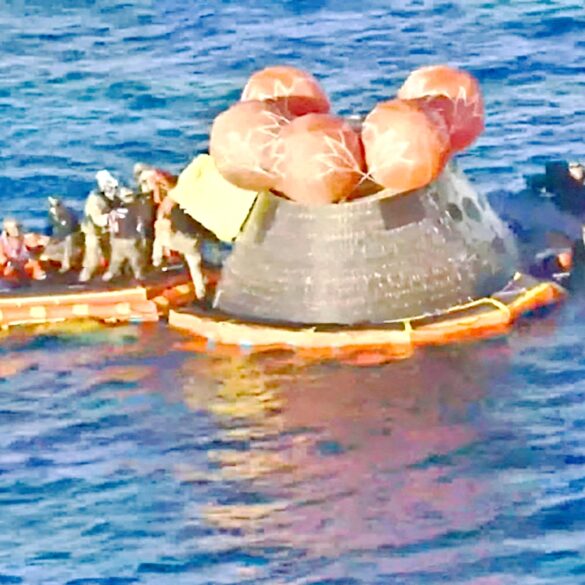 La cápsula Orión de la misión Artemis II flotando en el océano Pacífico rodeada de botes y personal de rescate tras el amerizaje frente a San Diego