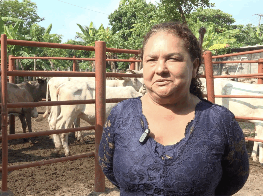Beneficiaria Leyla Pérez Pérez posando junto al corral de ganado de registro entregado por el programa Crédito a la Palabra.