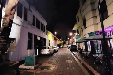 Calle del centro histórico de Villahermosa desierta en la noche, con negocios cerrados y ausencia de peatones