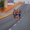 Corredores del Medio Maratón de Villahermosa avanzan por un puente urbano durante la prueba de 21 kilómetros.