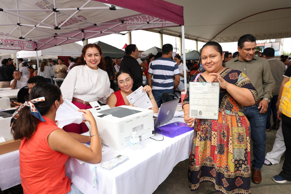 Mujer muestra un documento recibido durante la Jornada de Atención en Buenavista