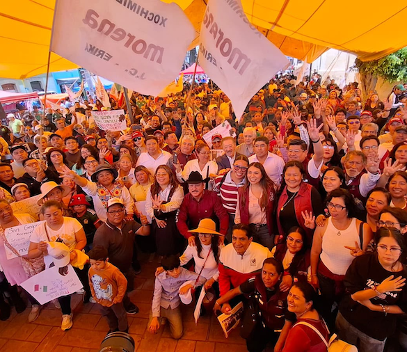 Militantes de Morena participan en una asamblea informativa con banderas y carteles sobre soberanía nacional.