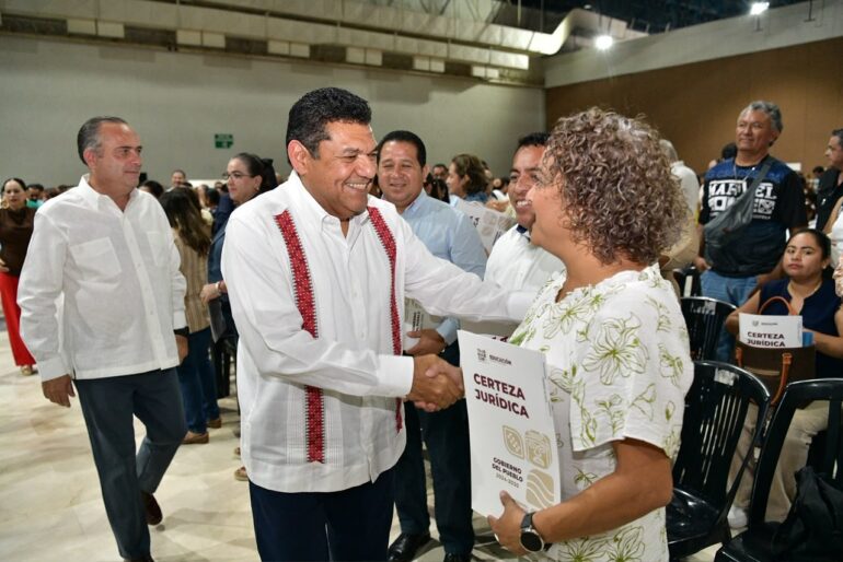 Directora escolar recibe documento de certeza jurídica durante la entrega de escrituras a escuelas en Villahermosa