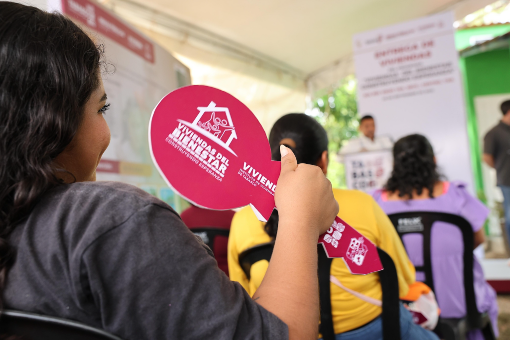 Mujer sostiene llave simbólica durante entrega de viviendas rurales en Tabasco