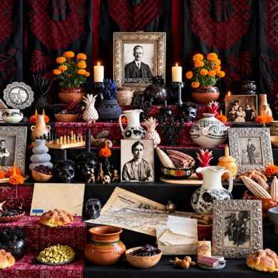 Ofrenda de Día de Muertos dedicada a Guillermo Kahlo en la Casa Azul, con retratos familiares, flores de cempasúchil, veladoras y objetos personales.